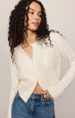Z SUPPLY Medina Pointelle Cardigan in Cloud, a cream button-front knit cardigan with pointelle texture, worn open over jeans, front view on model.
