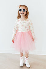 Mila Spring Kittens L/S Tutu Dress on young girl — floral kitten print bodice with pink tulle skirt, worn with white cowboy boots and pink sunglasses.