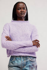 Opal Sweater in Purple Satin by Tempemail.Pdf — chunky knit mock-neck sweater in lavender, front view on model with jeans