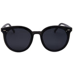 I-SEA Payton sunglasses in black with smoke polarized lenses, round frames, silver hardware accents, front view on white background.