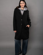 RD Style Despina Ladies Scuba Coat in black with notched lapels and two buttons, worn over a grey hoodie with wide-leg jeans, front view.