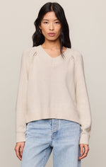 Z SUPPLY Stratton V-Neck Sweater in sandstone cream, featuring open-stitch raglan detail, ribbed hem and cuffs, worn by model with jeans