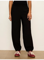 Sanctuary Micro Balloon Pant in black, worn by model with burgundy sneakers, showing relaxed tapered fit with elastic cuffs