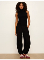 Sanctuary Micro Balloon Pant in black, front view on model paired with sleeveless turtleneck and burgundy sneakers