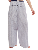 Free People Cross My Heart Lounge Pant in Ivory Combo, wide-leg striped pants with navy elastic waistband and button placket, front view on model.