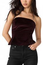 Steve Madden Dawnette Top in Deep Fig — strapless velvet peplum corset top in deep burgundy-purple, front view on model