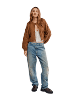 Free People Thistle Cardi in Macadamia, a cropped brown textured knit cardigan with balloon sleeves and button front, worn by a model with wide-leg distressed jeans.