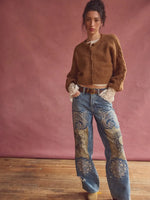 Free People Thistle Cardi in Macadamia, a cropped warm brown fuzzy knit cardigan with button front, worn by model with paisley jeans.