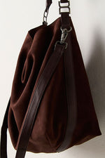 Free People Suzie Suede Slouch Tote in Espresso, dark brown slouchy bag with leather crossbody strap and gunmetal hardware, hanging view.