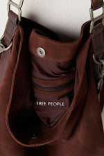 Free People Suzie Suede Slouch Tote in Espresso — interior close-up showing suede lining, zipper pocket, snap closure, and chain hardware