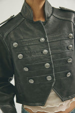 Free People Ryland Vegan Band Jacket in Black, close-up front view showing silver dome buttons and military-style detailing on model