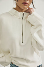 Free People Celeste Quarter-Zip in Clean Ivory — ribbed texture, half-zip closure, mock neck, oversized fit on model
