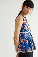 Free People Rome Printed Tank in Navy Combo, blue floral sleeveless top with lace trim, shown on model from side angle