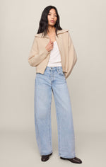 Z SUPPLY Silverlake Cardigan in Chalk, a cropped knit zip-up jacket with wide collar, worn open over white top with wide-leg jeans, front view on model.
