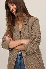 Z Supply Evan Check Blazer in dark chocolate houndstooth worn by model with arms crossed, showing lapels and button details
