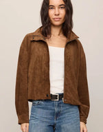 Z SUPPLY Corin Bubble Hem Jacket in Saddle Suede brown, worn open over white top with jeans, front view on model.