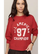 Z SUPPLY Champs Landmark Sweatshirt in Game Day Red, featuring 'All American 97 Champions' graphic, worn by a model, front view.