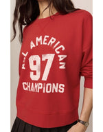 Z SUPPLY Champs Landmark Sweatshirt in Game Day Red with 'All American 97 Champions' graphic, worn by model, front view